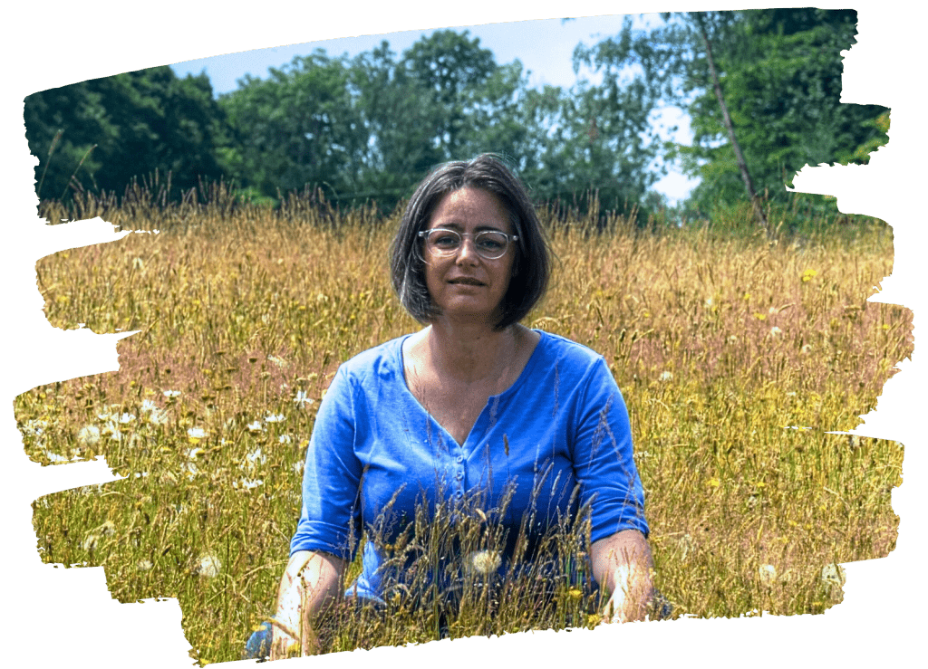 Headshot of counsellor Eefje in a field of wild flowers.